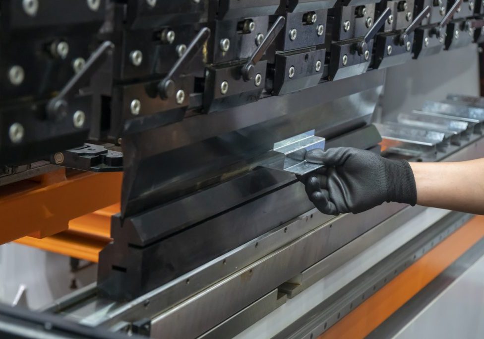 Operation of press brake hydraulic bending machine with forming die by skill operator. Secondary Operations, from Press Brake to Powder Coat